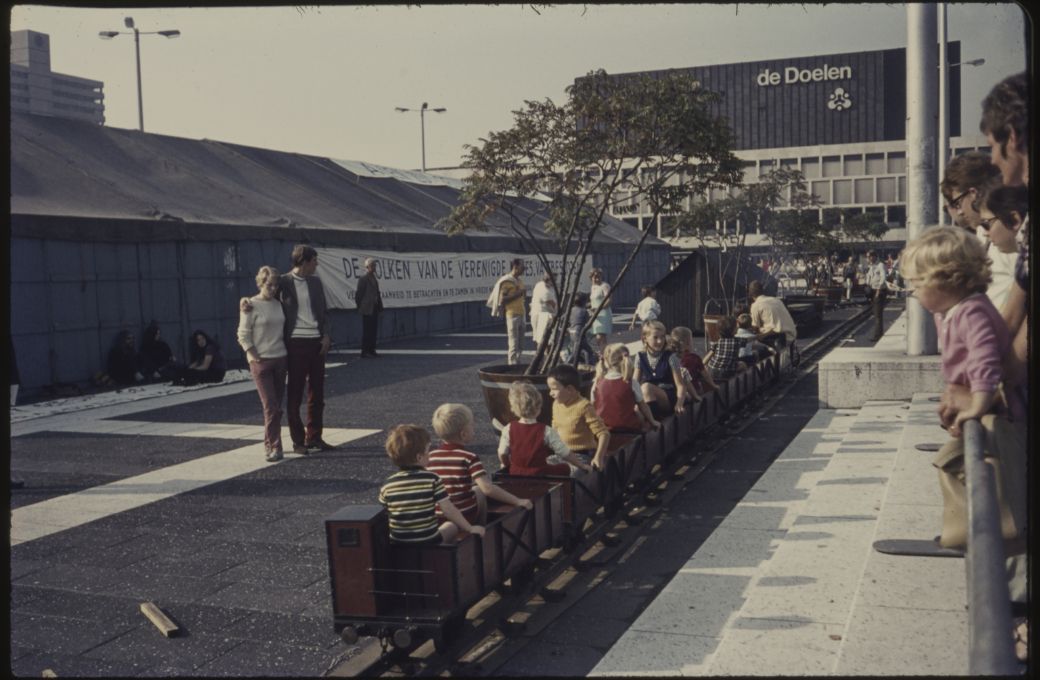 Children ride a miniature railway on Schouwburgplein, outside De Doelen concert hall, 1970. &copy; Stadsarchief Rotterdam | Public Domain
