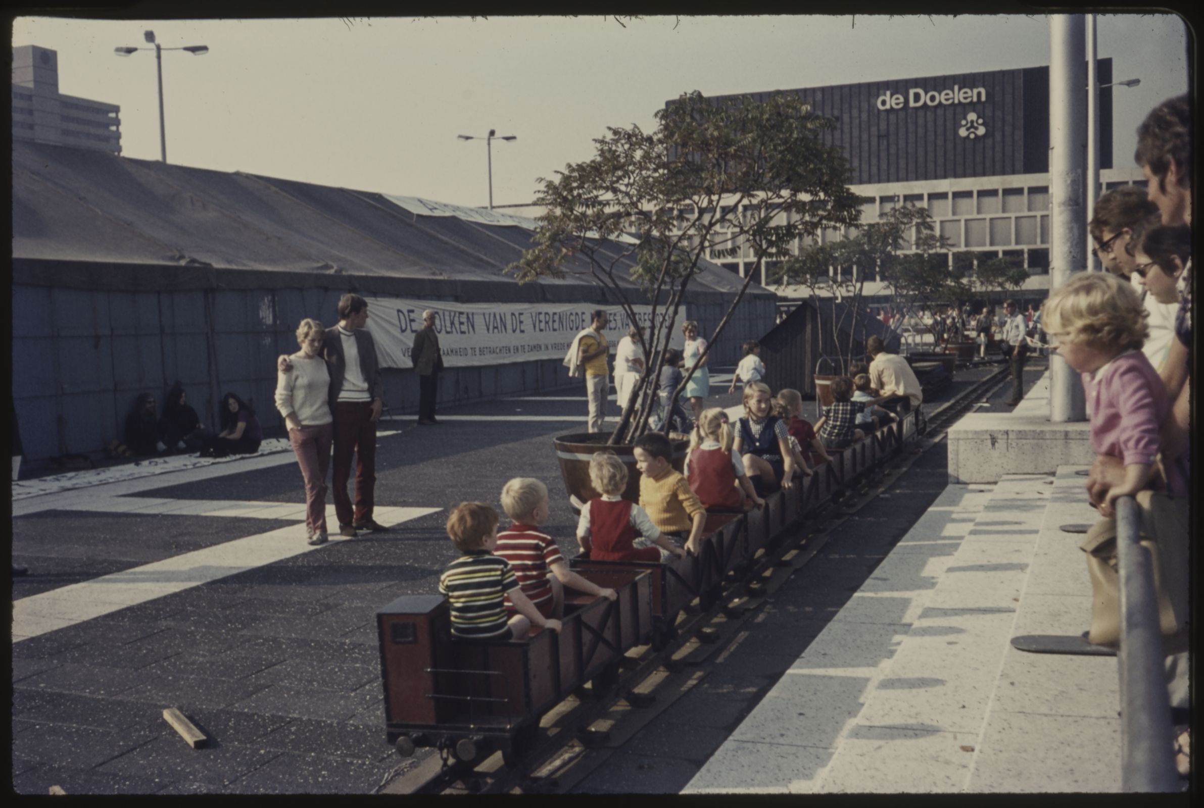 Children ride a miniature railway on Schouwburgplein, outside De Doelen concert hall, 1970. &copy; Stadsarchief Rotterdam | Public Domain