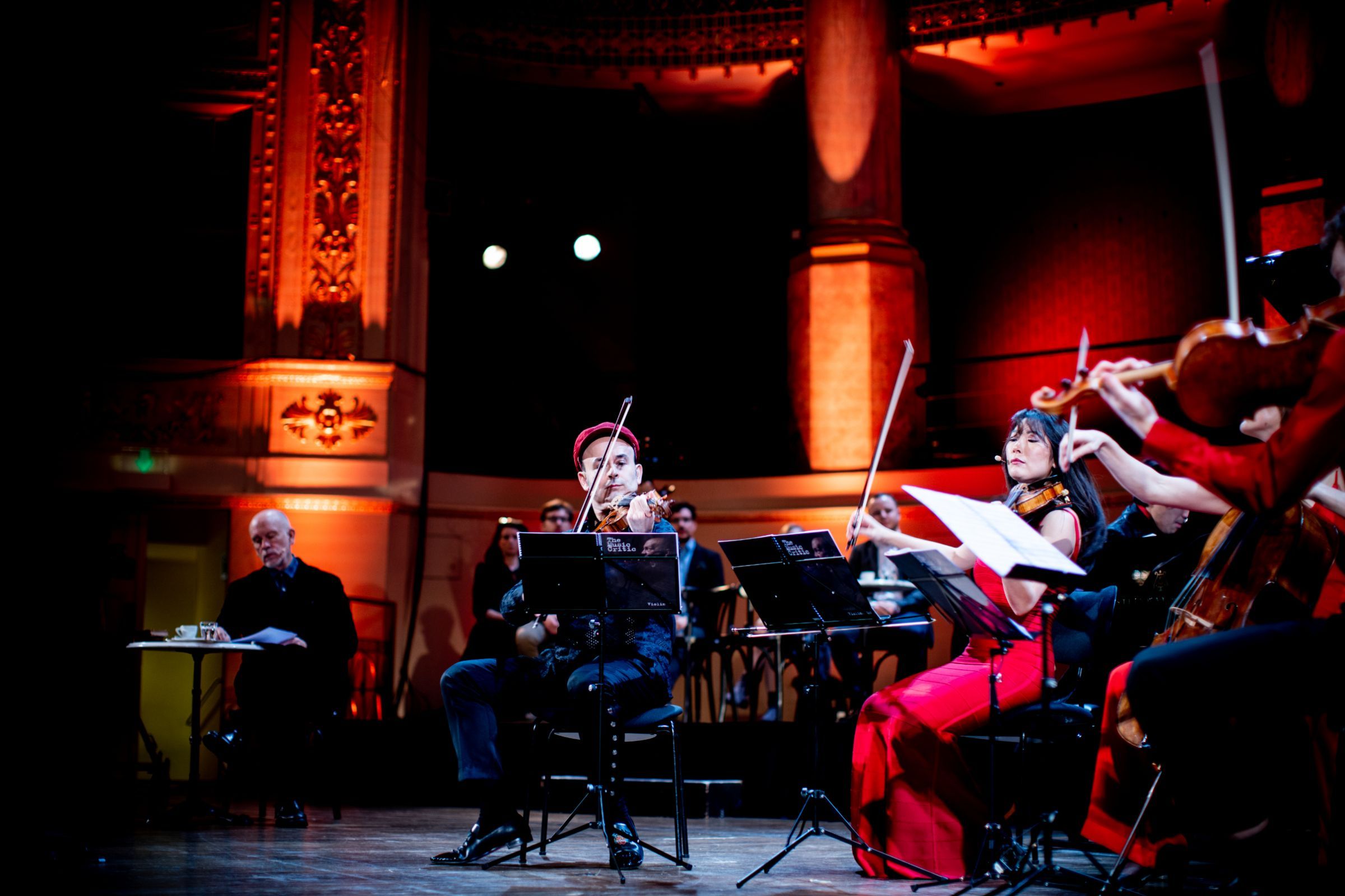 Alexey Igudesman leads musicians, while Malkovich looks on © Julia Wesely