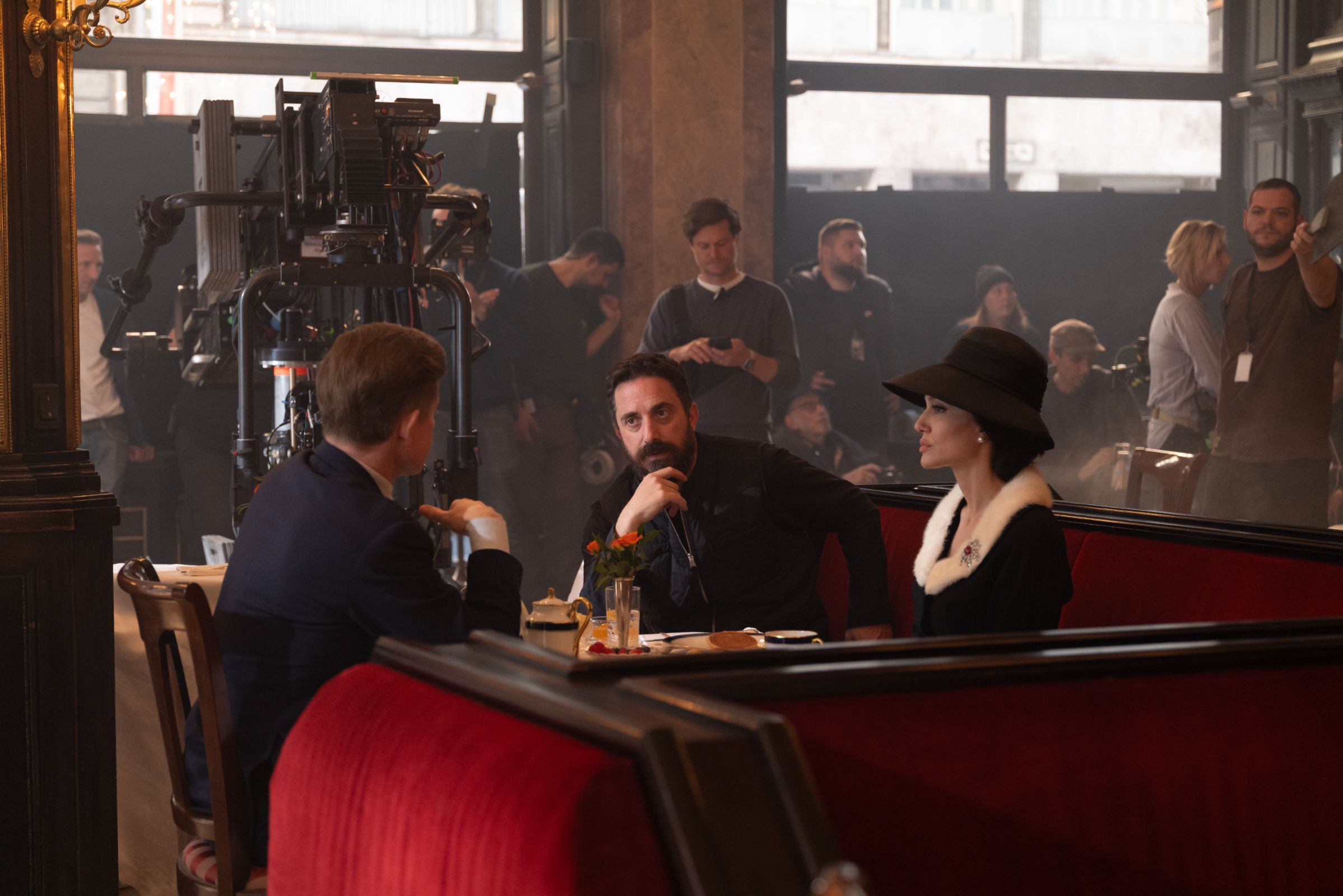 Pablo Larraín on set with Caspar Phillipson (John F Kennedy) and Angelina Jolie &copy; 2024 Netflix Inc | Photo by Pablo Larraín