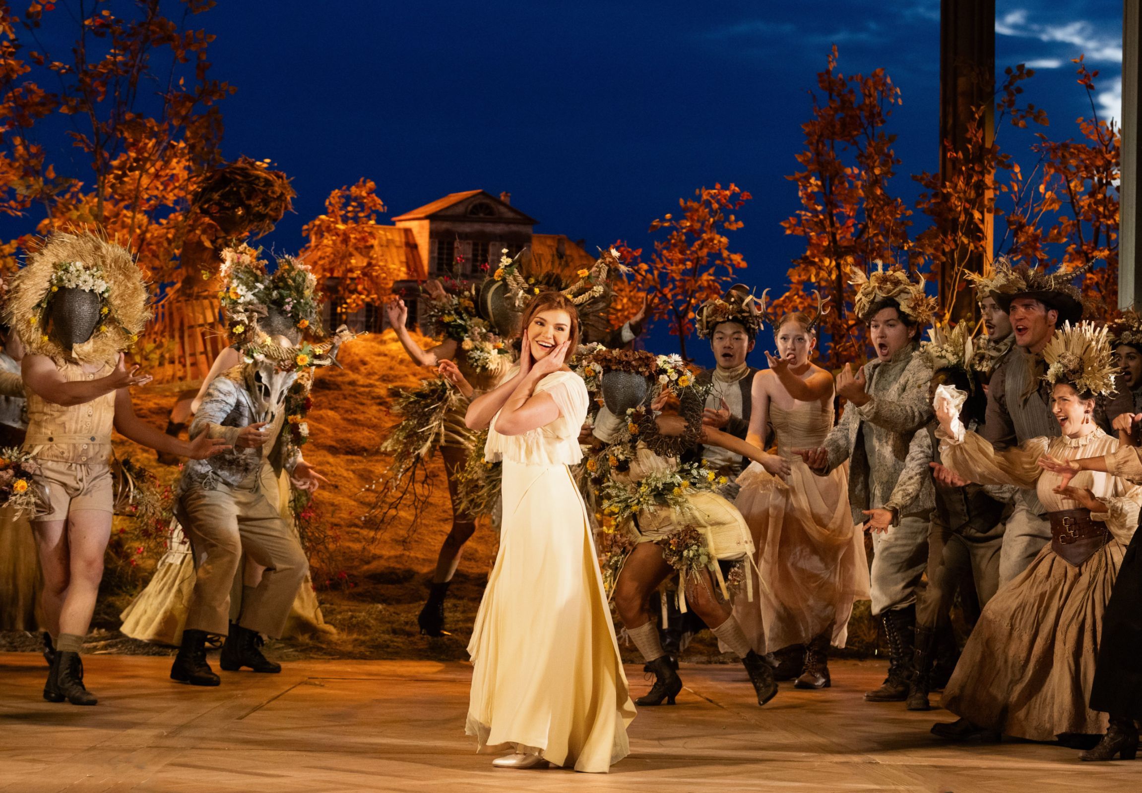 Olga Kulchynska (Tatyana) and members of the Santa Fe Opera Chorus &copy; Bronwen Sharp for Santa Fe Opera