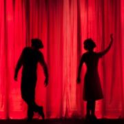Silhouettes on stage curtain &copy; Kyle Head | Unsplash