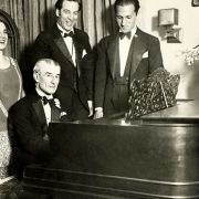Birthday party for Maurice Ravel in New York, 1928. Ravel at the piano; George Gershwin far right © Public domain