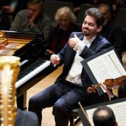 Lahav Shani directs the Munich Philharmonic from the keyboard &copy; Claudia Hoehne